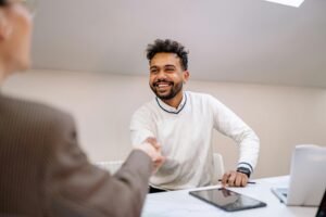 5 Keys to Build Positive Customer Experience image shows smiling man shaking hands with someone.
