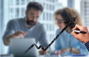 3 Ways Effective Coaching Unlocks Potential. Image shows an arrow pointing upward and to the right over a blurred image of a man coaching a woman on a laptop.